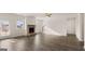Open floor plan featuring hardwood floors, a stone fireplace, and a backyard walkout at 1712 Goodwin Dr, Hampton, GA 30228