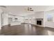 Open layout showcasing the living room with a stone fireplace, next to the kitchen with island and breakfast nook at 1712 Goodwin Dr, Hampton, GA 30228