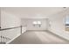 Spacious loft area with plush carpeting and natural light from multiple windows at 1712 Goodwin Dr, Hampton, GA 30228