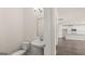 Bright powder room with a pedestal sink and modern fixtures near the kitchen at 1712 Goodwin Dr, Hampton, GA 30228