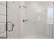 Glass enclosed shower featuring white subway tile, a shower head, and shelving at 1712 Goodwin Dr, Hampton, GA 30228