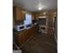 Traditional kitchen with wood cabinets, stainless sink, and tiled backsplash at 452 Fedora Nw Way, Atlanta, GA 30331