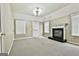 Finished basement area with a fireplace, carpeting, and natural light from the windows at 165 Standing Oak Pl, Fayetteville, GA 30214