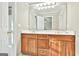 Bathroom featuring double vanity with wood cabinets, a large mirror, and bright lighting at 165 Standing Oak Pl, Fayetteville, GA 30214