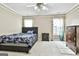 Cozy bedroom with carpet flooring, a ceiling fan, and two windows providing natural light at 165 Standing Oak Pl, Fayetteville, GA 30214