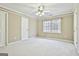 A simple bedroom featuring carpet and natural light from the window at 165 Standing Oak Pl, Fayetteville, GA 30214
