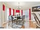 Charming dining room featuring a stylish table set with red drapes for elegant touch at 165 Standing Oak Pl, Fayetteville, GA 30214