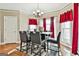 Elegant dining room with a pendant light, many windows, and a stylish table set at 165 Standing Oak Pl, Fayetteville, GA 30214