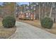 Charming two-story red brick home with well-manicured landscaping and a long driveway leading to the house at 165 Standing Oak Pl, Fayetteville, GA 30214