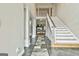 Elegant foyer with a staircase, high ceilings, and a view into the living room with a fireplace at 165 Standing Oak Pl, Fayetteville, GA 30214