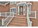 Detailed shot of a home's front door with brick steps, a small porch, and an oval glass window at 165 Standing Oak Pl, Fayetteville, GA 30214