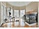 The bonus room features a fireplace, natural light, hardwood floors and space for a home gym at 165 Standing Oak Pl, Fayetteville, GA 30214