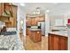 Bright kitchen with granite countertops, wood cabinetry, and stainless steel appliances at 165 Standing Oak Pl, Fayetteville, GA 30214