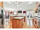Open kitchen with stainless steel appliances, granite countertop, and access to dining area at 165 Standing Oak Pl, Fayetteville, GA 30214
