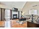 Inviting living room featuring a fireplace, large windows, and comfortable seating at 165 Standing Oak Pl, Fayetteville, GA 30214