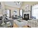 Bright living room featuring a fireplace, vaulted ceilings, and a plush rug over hardwood floors at 165 Standing Oak Pl, Fayetteville, GA 30214