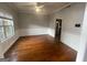 Dining room with wood floors, large window, and modern lighting at 7228 Silverleaf Cir, Fairburn, GA 30213