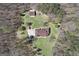 Expansive aerial view of the property featuring a home, garage, and surrounding wooded area at 7395 Old Rico Rd., Chattahoochee Hills, GA 30268