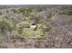 Sprawling property featuring a well-maintained home, lush lawn, detached garage, and surrounded by dense trees offering privacy at 7395 Old Rico Rd., Chattahoochee Hills, GA 30268
