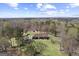 Aerial view of a brick home with lush surroundings and a detached garage at 7395 Old Rico Rd., Chattahoochee Hills, GA 30268
