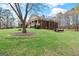 Brick home with a well-maintained lawn and mature trees in the backyard at 7395 Old Rico Rd., Chattahoochee Hills, GA 30268