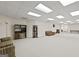 Spacious finished basement features a striped sofa and a leather chair with bright lighting at 7395 Old Rico Rd., Chattahoochee Hills, GA 30268
