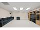 Finished basement offers a comfortable seating arrangement with modern entertainment center at 7395 Old Rico Rd., Chattahoochee Hills, GA 30268