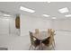 Carpeted basement features a table and chairs for activities and storage at 7395 Old Rico Rd., Chattahoochee Hills, GA 30268