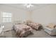 Neutral bedroom featuring two beds, carpeted flooring, and bright natural light from the window at 7395 Old Rico Rd., Chattahoochee Hills, GA 30268