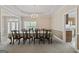 Well-lit dining room featuring a long table with seating for ten under a decorative chandelier fixture at 7395 Old Rico Rd., Chattahoochee Hills, GA 30268