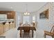 Traditional dining room features a chandelier, floral wallpaper, and plenty of natural light from the bay window at 7395 Old Rico Rd., Chattahoochee Hills, GA 30268