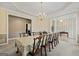 Elegant dining room featuring a large table with seating for ten under a beautiful chandelier at 7395 Old Rico Rd., Chattahoochee Hills, GA 30268