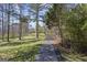 Long driveway winding through lush greenery, leading to a secluded home at 7395 Old Rico Rd., Chattahoochee Hills, GA 30268