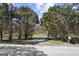 Gated driveway leading to the secluded property, lined with mature trees at 7395 Old Rico Rd., Chattahoochee Hills, GA 30268