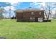 A spacious brick home with a well-manicured lawn and mature trees on a sunny day at 7395 Old Rico Rd., Chattahoochee Hills, GA 30268