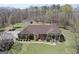 Stunning brick home features a sprawling lawn, covered parking, and a detached garage at 7395 Old Rico Rd., Chattahoochee Hills, GA 30268