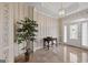 Inviting foyer with tiled floor, decorative wallpaper, and natural light filtering through the glass-paned front door at 7395 Old Rico Rd., Chattahoochee Hills, GA 30268