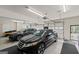 A spacious garage with two cars parked inside, each with ample space for storage and movement at 7395 Old Rico Rd., Chattahoochee Hills, GA 30268