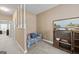 Hallway showcasing a floral couch and a decorative bookshelf, providing a welcoming and stylish transition space at 7395 Old Rico Rd., Chattahoochee Hills, GA 30268