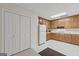 Kitchen features wooden cabinets, white appliances, and light vinyl flooring at 7395 Old Rico Rd., Chattahoochee Hills, GA 30268