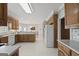 Spacious kitchen with ample counter space, a breakfast bar, and white appliances for modern convenience at 7395 Old Rico Rd., Chattahoochee Hills, GA 30268