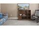 Cozy living area features a floral sofa, rocking chair and shelving with decorative landscape art at 7395 Old Rico Rd., Chattahoochee Hills, GA 30268