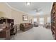 Cozy living room with neutral paint, plush carpet, sofa, desk and chair at 7395 Old Rico Rd., Chattahoochee Hills, GA 30268