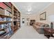 Spacious living room with large bookshelves, sofa, desk and chair at 7395 Old Rico Rd., Chattahoochee Hills, GA 30268