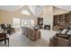 Spacious living room with vaulted ceilings, a fireplace, and built-in bookcases for an inviting atmosphere at 7395 Old Rico Rd., Chattahoochee Hills, GA 30268