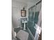 Bathroom featuring a pedestal sink and framed shower with blue tile accents at 2518 Caladium Ne Dr, Atlanta, GA 30345