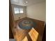 Bedroom features hardwood floors, neutral walls, natural light from the window, and a round area rug at 2518 Caladium Ne Dr, Atlanta, GA 30345