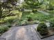 Landscaped front yard with brick paver walkway and mature trees providing shade at 2518 Caladium Ne Dr, Atlanta, GA 30345