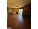 Spacious living room with brick fireplace, ceiling fan, and access to outdoor deck at 2518 Caladium Ne Dr, Atlanta, GA 30345