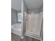 Bright bathroom with tub and separate shower, and large window at 1105 Bradford Park Dr, Auburn, GA 30011